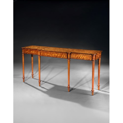 A regency breakfront satinwood side table